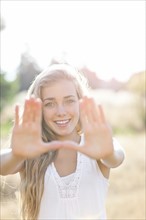 Teenage girl (16-17) displaying stop gesture. Photo : Take A Pix Media