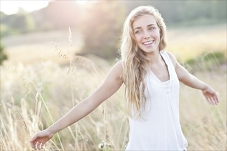 Happy teenage girl (16-17) enjoying bright sunshine. Photo : Take A Pix Media