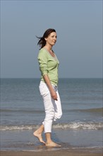 Woman on beach. Photo : Jan Scherders