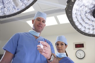 Male and female surgeons in operating room. Photo: db2stock