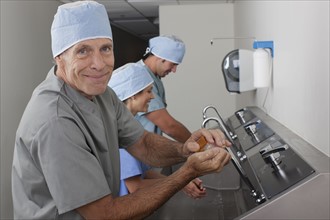 Surgeons washing hands in hospital. Photo : db2stock