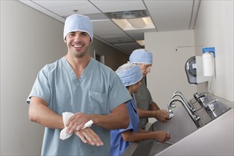 Surgeons washing hands in hospital. Photo : db2stock