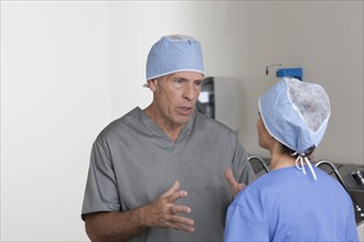 Male and female surgeons talking. Photo: db2stock