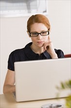 Businesswoman using laptop. Photo: Rob Lewine