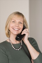 Portrait of businesswoman talking on phone. Photo : Rob Lewine