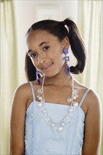 Portrait of girl (10-11) wearing elegant clothes and jewelry. Photo: Rob Lewine