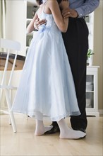 Low section of Father and Daughter (10-11) dancing in kitchen. Photo : Rob Lewine