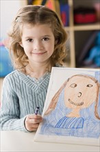 Portrait of smiling girl (6-7) showing her drawing. Photo : Rob Lewine