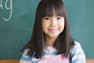 Portrait of girl (6-7) in classroom. Photo : Rob Lewine