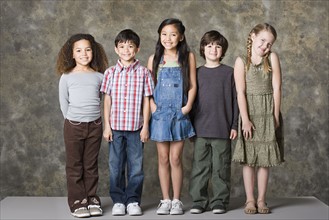 Children (6-7, 8-9) posing, studio shot. Photo : Rob Lewine