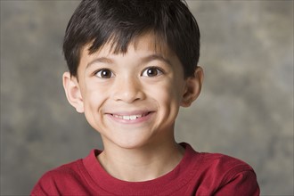 Portrait of smiling boy (8-9), studio shot. Photo : Rob Lewine
