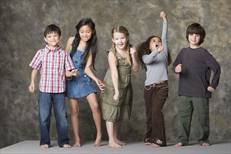 Children (6-7, 8-9) dancing together, studio shot. Photo : Rob Lewine