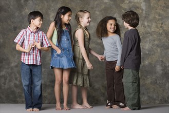 Children (6-7, 8-9) playing together, studio shot. Photo : Rob Lewine