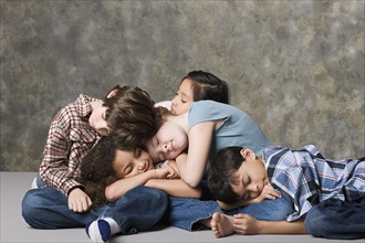 Children (6-7, 8-9) sleeping together, studio shot. Photo: Rob Lewine