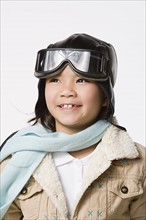 Portrait of smiling boy (8-9) wearing pilot hat and jacket, studio shot. Photo : Rob Lewine