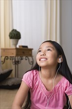 Portrait of smiling girl (8-9) with headphones. Photo : Rob Lewine