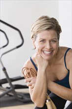 Portrait of smiling woman in gym. Photo: Rob Lewine