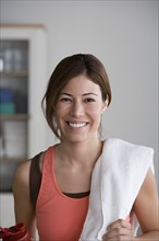 Portrait of smiling woman in gym. Photo : Rob Lewine