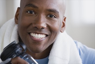 Portrait of smiling young man in gym. Photo : Rob Lewine