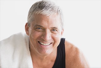 Portrait of smiling mature man in gym. Photo : Rob Lewine