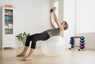 Woman exercising with fitness ball. Photo : Rob Lewine