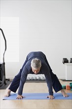 Man stretching in gym. Photo: Rob Lewine