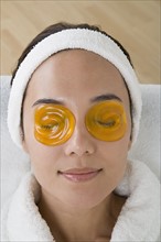Woman relaxing with eye cooling mask. Photo: Rob Lewine