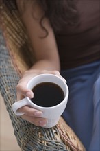 Hand holding cup of coffee. Photo: Rob Lewine