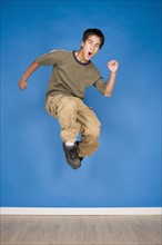 Portrait of teenage boy (16-17) jumping. Photo : Rob Lewine