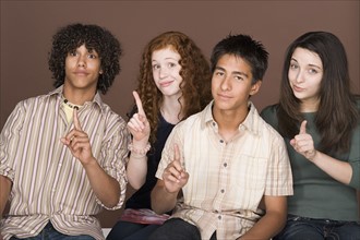 Portrait of teenagers (14-15,16-17) with fingers up. Photo: Rob Lewine