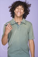 Portrait of teenage boy (14-15) listening music. Photo : Rob Lewine