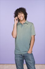 Portrait of teenage boy (14-15) talking on mobile phone. Photo : Rob Lewine