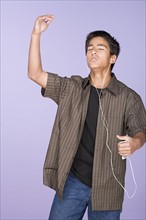 Portrait of teenage boy (16-17) listening music. Photo : Rob Lewine
