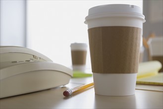 Plastic coffee cup on desk. Photo : Rob Lewine