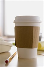 Plastic coffee cup on desk. Photo : Rob Lewine
