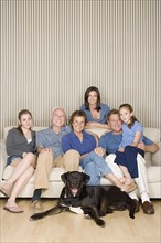 Portrait of three-generation family with two girls (8-9, 14-15) and dog. Photo : Rob Lewine