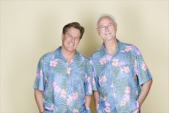 Portrait of father with adult son wearing Hawaiian shirts. Photo : Rob Lewine