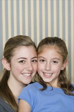 Portrait of two happy girls (14-15, 8-9). Photo : Rob Lewine
