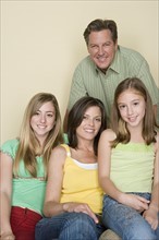 Portrait of happy three-generation family with two girls (8-9, 14-15). Photo : Rob Lewine