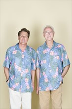 Portrait of senior man with adult son wearing Hawaiian shirts. Photo : Rob Lewine