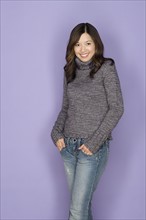 Portrait of happy asian woman wearing wooly jumper. Photo : Rob Lewine