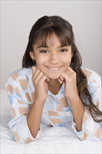 Portrait of smiling girl (10-11) in pajamas. Photo : Rob Lewine