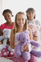 Portrait of three smiling girls (10-11) with puppets. Photo: Rob Lewine