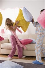Two girls (10-11) having pillow fight at slumber party. Photo: Rob Lewine