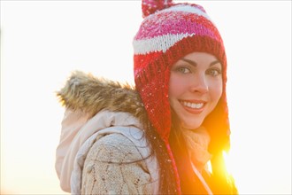 Portrait of young woman wearing knit hat.