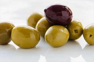 Close-up of black and green olives, studio shot.