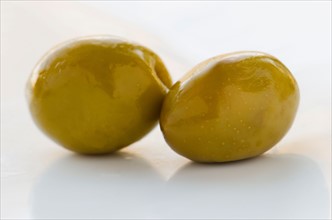 Close-up of green olives, studio shot.
