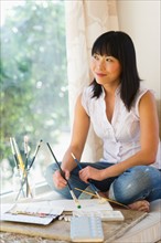 Mid adult woman painting at home.