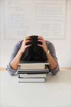 Frustrated woman in front of board with equations.