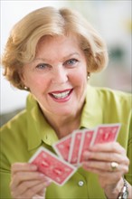 Senior woman playing cards.